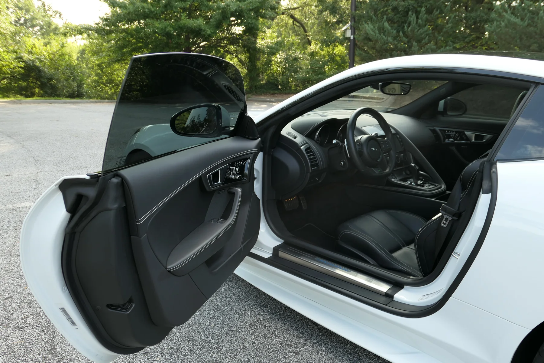 Driver door open showing the Jet Black cabin